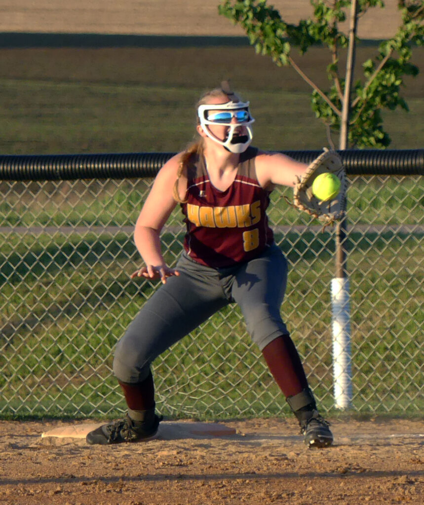 First baseman Eliza Tewes records the last putout of the Hawks’ 7-4 victory over Trinity Christian.