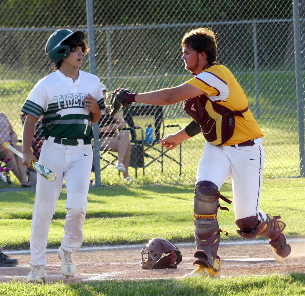 Catcher Evan Eilers remedies a dropped third strike by tagging out Trinity Christian batter Breck Brummel.