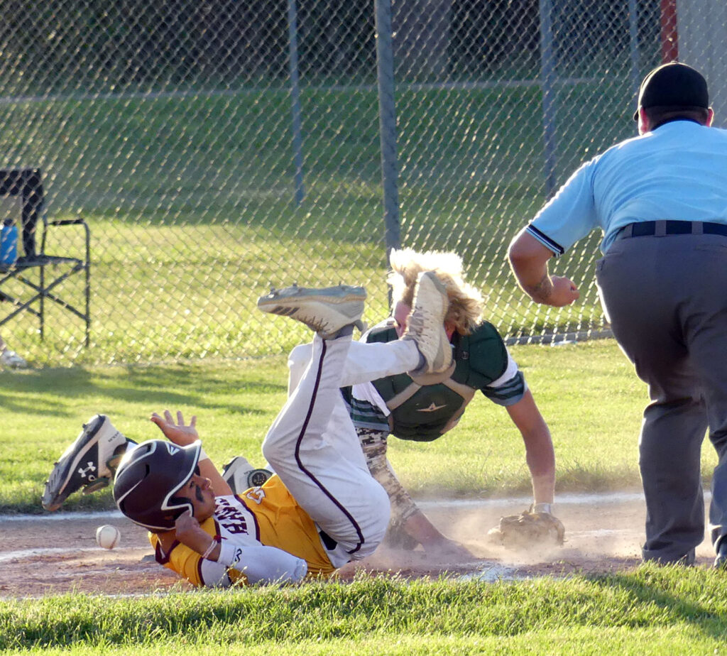 Jonny Ortiz is safe at home after Trinity Christian catcher Josh Kooiker was unable to hold onto the baseball.