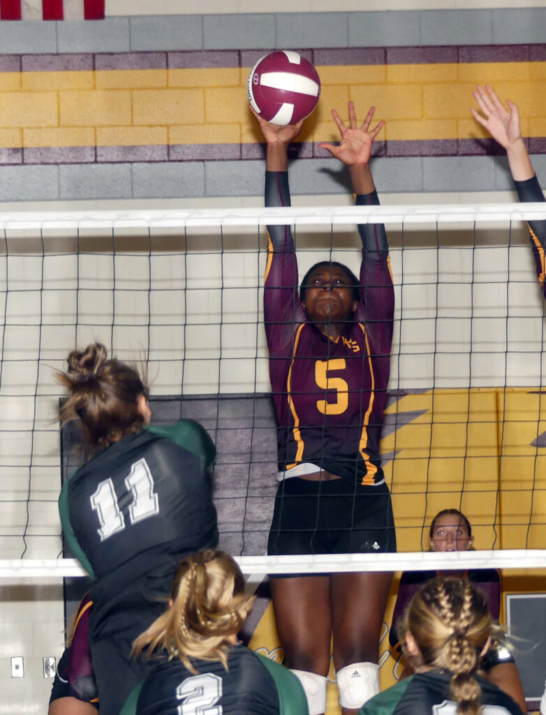 Emily Mutombo tries to get a hand on an attack from Trinity Christian’s Avery Van Maanen.