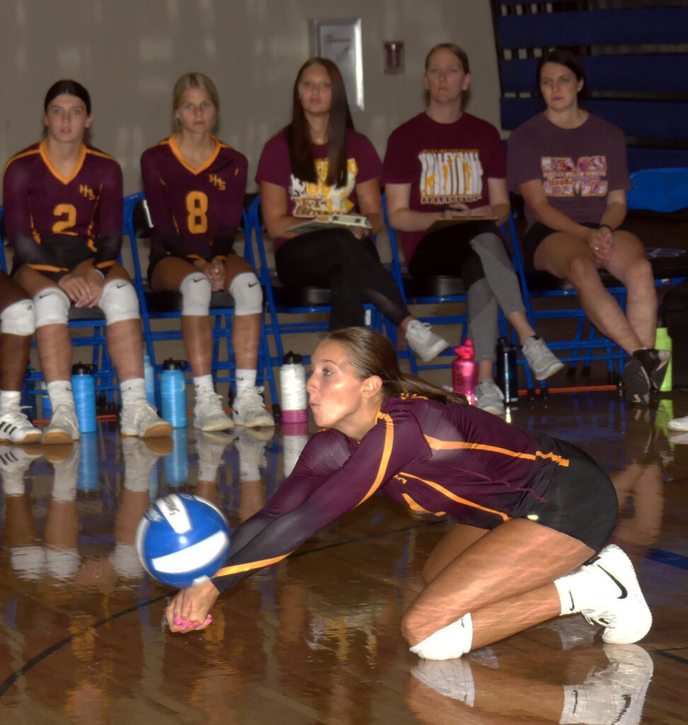 Abby Kunzman gets low to intercept a West Sioux serve.